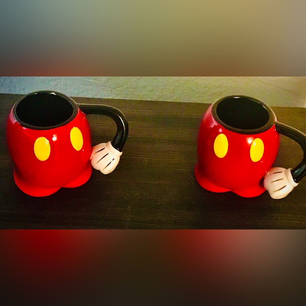 Two Mickey Mouse half-body mugs with yellow buttons